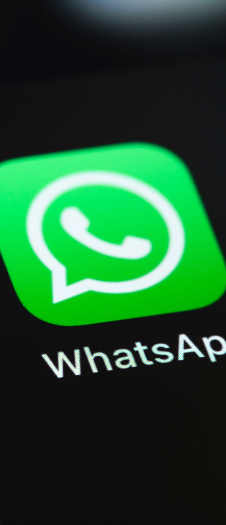 A picture featuring a WhatsApp logo on a mobile.